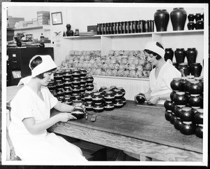 Two women labeling honey jars for the Southwest Honey Producer's Syndicate, 1930-1940