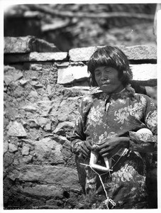 Hopi Indian knitting a stocking, ca.1901