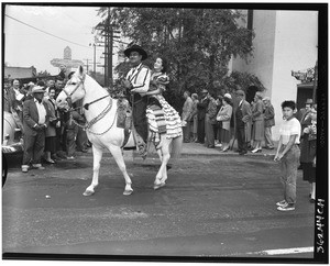 Man and a woman on a horse on Sunset Boulevard, Los Angeles