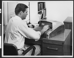 Engineer working with Litton 20, a "revolutionary new" electronic digital computer by Litton Industries, ca.1940