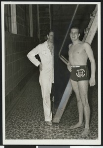 Coach Tex Robertson standing with swimmer Adolph Kieter of the All America Swimming Team, ca.1930