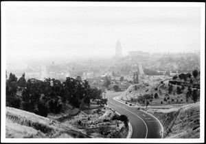 Panoramic view of the completed lanes of North Figueroa Street, looking south from Spruce street, showing hills and parked automobiles, ca.1936