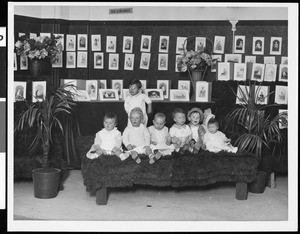 A group portrait of babies on a platform, ca.1920-1930