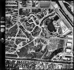 Aerial view of Century City showing an assortment of buildings and a lake, May 6, 1959