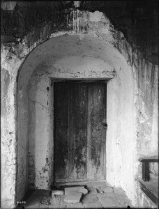 Arch and door at the east end of the north corridor at Mission San Juan Capistrano, California, ca.1908