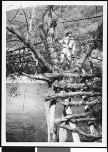 Man on a bridge over a river in Mexico, ca.1905