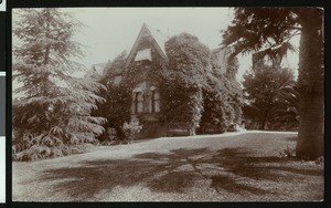 Exterior view of a vine-grown Victorian home in Redlands, ca.1900