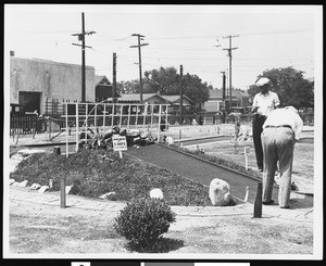 A miniature golf course near a street, ca.1930