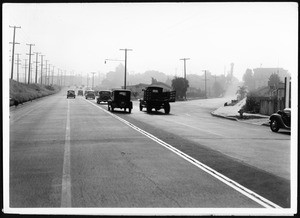 View of Venice Boulevard looking east from Lomita Street after construction of storm drain and widening of roadway, 1938