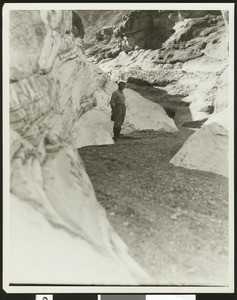 Unidentified man standing in a rocky canyon