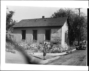 Young woman in front of the first church and school in La Crescenta, ca.1940