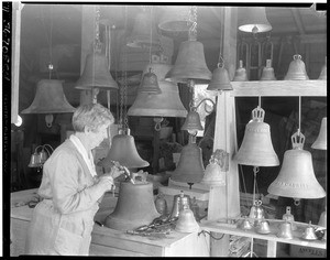 Mrs. A. S. C. Forbes chiseling at a bell, ca.1930