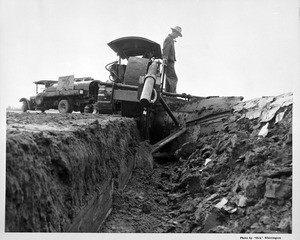 Man operating a giant plow in Santa Ana, ca.1930-1934