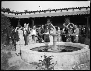 Group of Mexican dancers beside a circular fountain