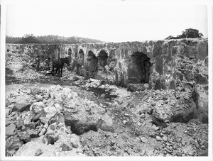 Two men removing stones from the ruin of Mission Santa Margarita, ca.1906