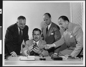 Four Lear Corporation Research and Development Division workers examining a component, September 1950