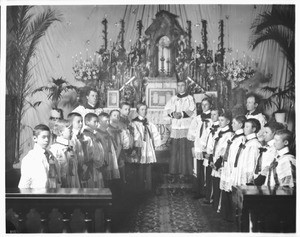 Altar boys and priests standing in front of the Plaza Church altar, Los Angeles, November 20, 1900