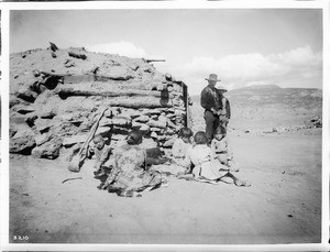 Peshliki, a Navajo Indian silversmith, and his family outside his shop (and hogan) on the Tohatchi Indian Reservation near Gallup, New Mexico, ca.1900