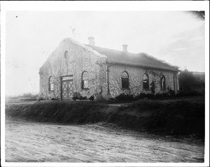 Exterior view of the ivy-covered Corona Water Works building, ca.1900