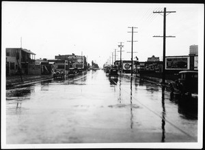 Slauson Avenue west from Third Avenue after storm drain construction, during a violent rain, 1930-1939