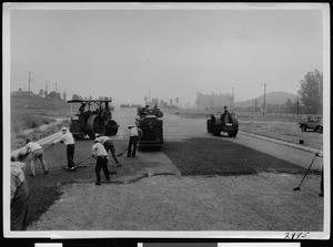 Laying bituminous pavement on Alhambra Avenue near Valley Boulevard