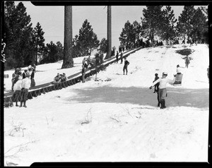 Children playing by a sledding trail in Big Pines Camp