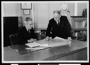 Workers from the Department of Public Works inside of an office