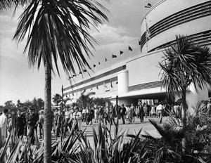 Exterior view of the Hollywood Park Race Track, showing building with flags, possibly ca.1936-1939