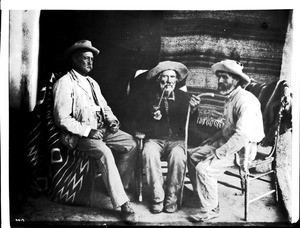 Three Indian fighters shown indoors, at the pueblo of Cibolleta, New Mexico, ca.1900