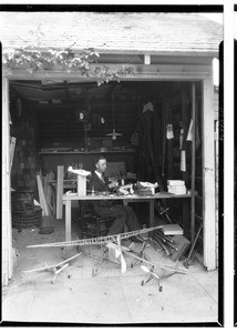 L. R. Miller making model airplanes in his garage in Pasadena, June 1, 1929