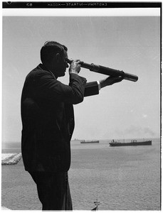 Man with a telescope at the Marine Exchange in Los Angeles Harbor