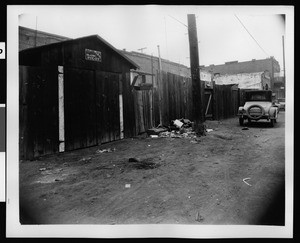 Olvera Street, showing an automobile, ca.1930-1939