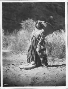 Havasupai Indian woman, Ta-ya-ba, carrying a "Kathak" or basket on her back, ca.1900