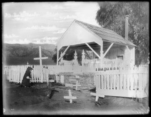 Woman kneeling at Campo Santo, the cemetery at Camulos Ranch, California