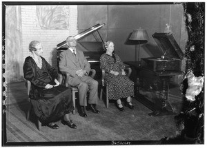 Three blind people sitting and listening to a "talking book", ca.1928