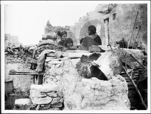 Hopi ("Moki") Indian family in front of their house at Oraibi, Arizona, ca.1900