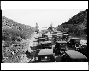 Automobiles clustered at the opening of the Mulholland Highway, December 1924