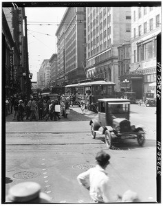 Pedestrians crossing a street in front of a streetcar, Los Angeles