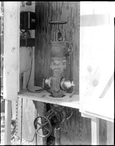 Valve on a C.C.M Oil Company photo electric "bleeder" for separating the water on sixty wells, ca.1920