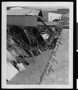 Flood damage to Warner Brothers Studio, showing a falling building, 1938