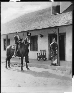 Caballero Edmundo Ontivares on horseback in front of the Ontivares adobe, ca.1925