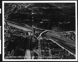 Aerial view of a flooding Los Angeles River at a Southern Pacific Railroad bridge near Elysian Park, 1938