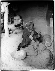 Chemehuevi Indian woman basket maker, making splints, ca.1900