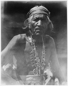 Portrait of a Navajo Captain wearing his war headdress and solid silver ornaments, ca.1900