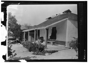 Exterior view of a small house, showing the front porch