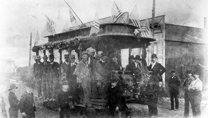 Portrait of operators and passengers on and around the first successful electric streetcar in Los Angeles, ca.1885