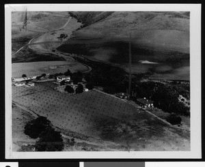 Houses in a hillside area, showing flooded crops