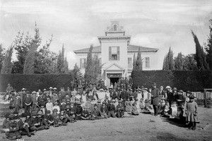 Group of students and their principal, Professor Little, outside of the Pomona Valley Central School at the northwest corner of Ellen Place, ca.1884