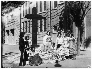 View of a group of people gathered around a commemorative monument for Felipe de Neve