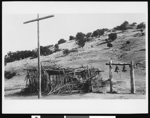 Bells, cross and thatched arbor at the Asistencia Santa Ysabel at the Mission San Diego Alcala, 1905